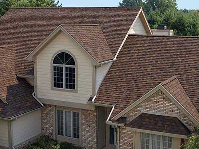 Mid-class home with red Owens Corning shingles on its roof